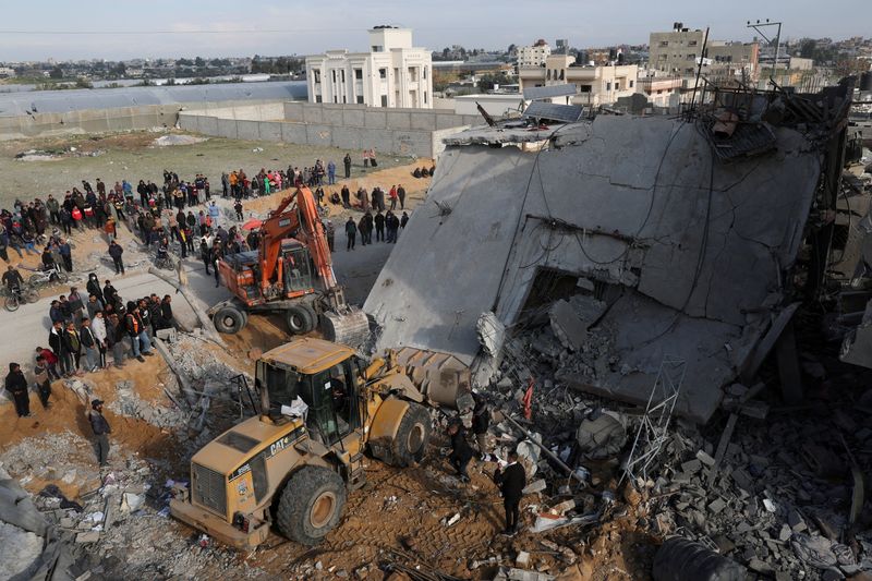 FILE PHOTO: Palestinians inspect a house hit by an Israeli strike, in Rafah in the southern Gaza Strip